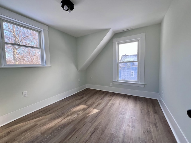 additional living space with dark hardwood / wood-style floors