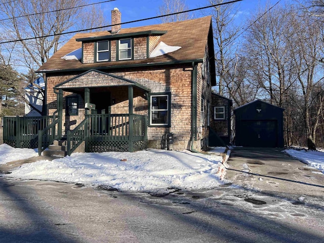 view of front of house with a garage, an outdoor structure, and covered porch