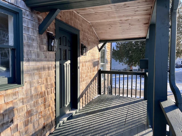 wooden terrace featuring covered porch