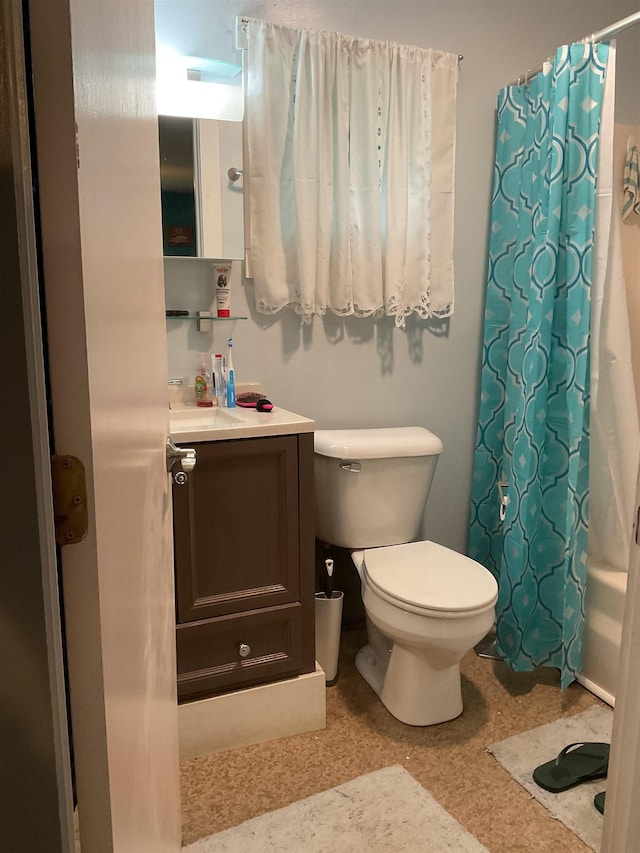 full bathroom with vanity, shower / tub combo with curtain, and toilet