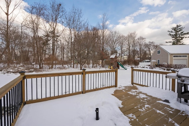 snow covered deck with a playground