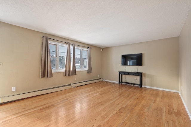 unfurnished living room featuring light wood-type flooring, a textured ceiling, and baseboard heating