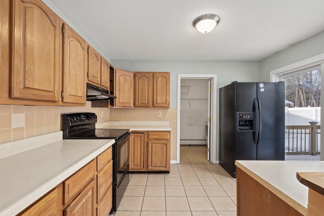 kitchen with black appliances, a textured ceiling, light tile patterned floors, a baseboard radiator, and backsplash