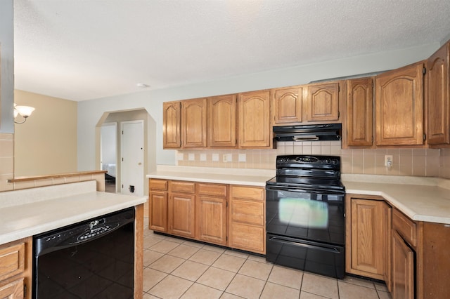 kitchen featuring light tile patterned floors, backsplash, black appliances, and exhaust hood