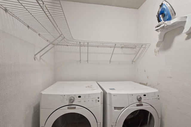 clothes washing area featuring independent washer and dryer