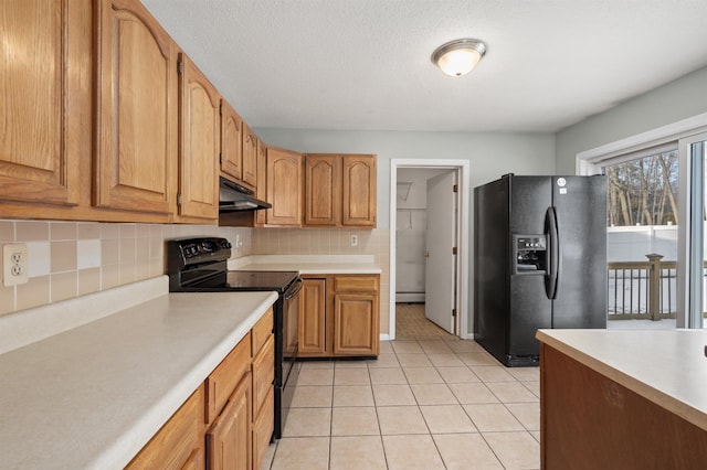 kitchen featuring light tile patterned floors, tasteful backsplash, black appliances, a textured ceiling, and a baseboard radiator