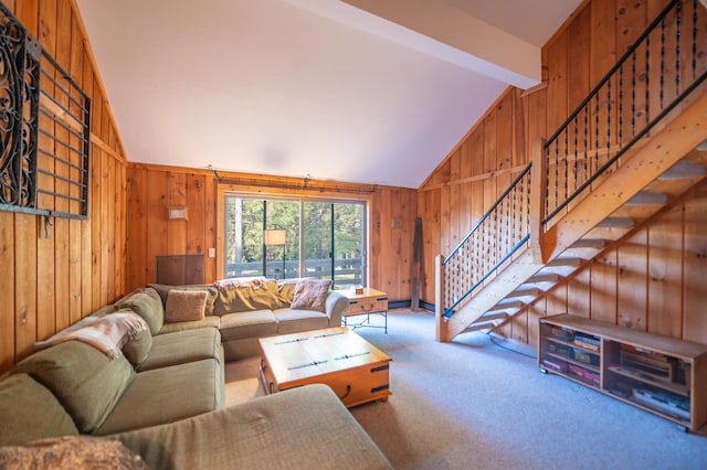 living room with lofted ceiling with beams, carpet, and wood walls