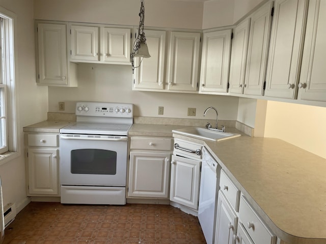 kitchen featuring sink, white appliances, hanging light fixtures, and white cabinets