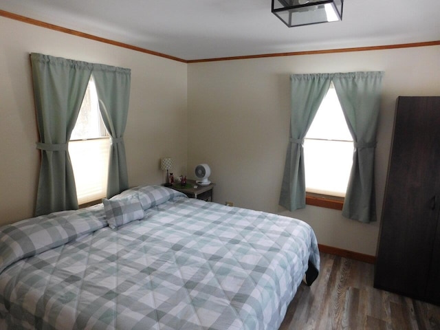 bedroom featuring crown molding and hardwood / wood-style flooring