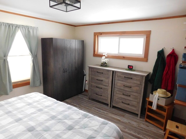 bedroom with dark wood-type flooring and crown molding