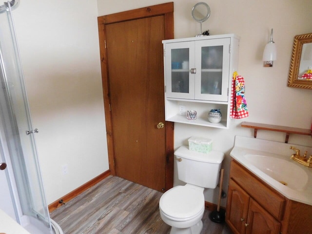 bathroom featuring vanity, hardwood / wood-style floors, and toilet