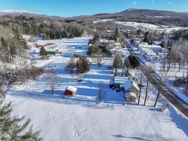 snowy aerial view with a mountain view