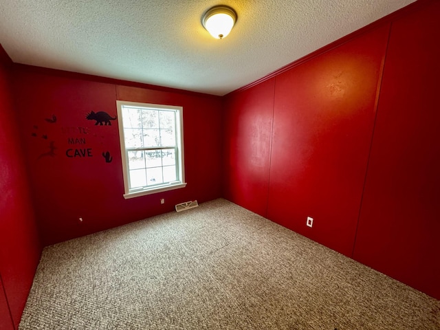 unfurnished room featuring carpet floors and a textured ceiling