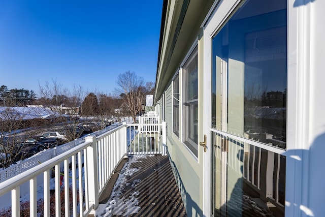 view of snow covered back of property