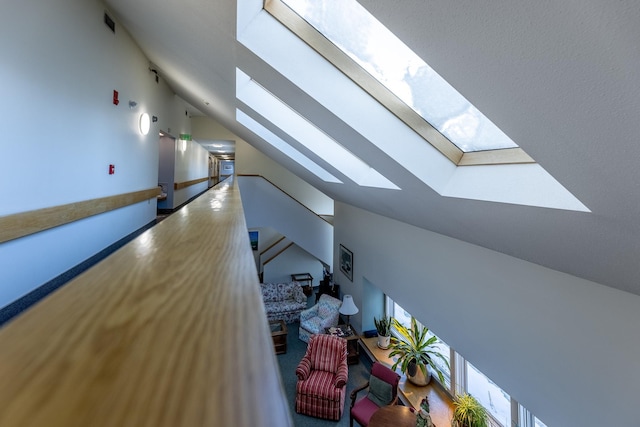 interior space with vaulted ceiling with skylight