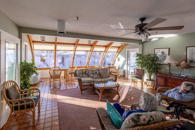 sunroom featuring ceiling fan and a healthy amount of sunlight