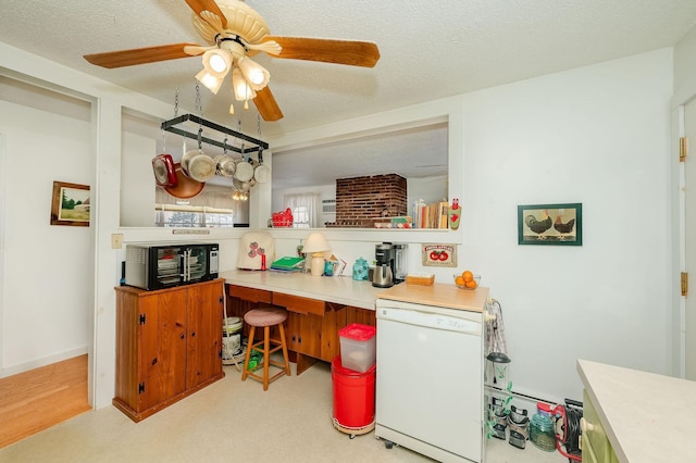 kitchen with white dishwasher, ceiling fan, and a textured ceiling