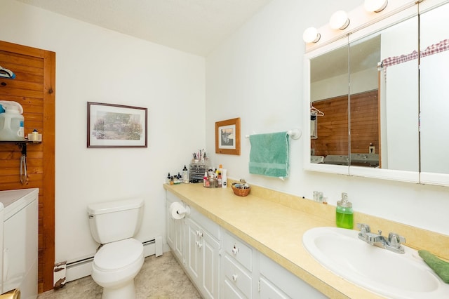 bathroom featuring a baseboard radiator, vanity, toilet, and washer and dryer