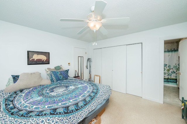 bedroom with light colored carpet, a textured ceiling, ceiling fan, and a closet