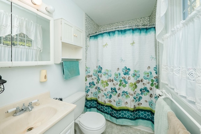 full bathroom featuring shower / bath combination with curtain, vanity, and toilet