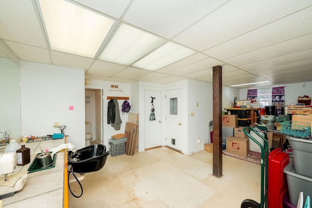 basement with a paneled ceiling