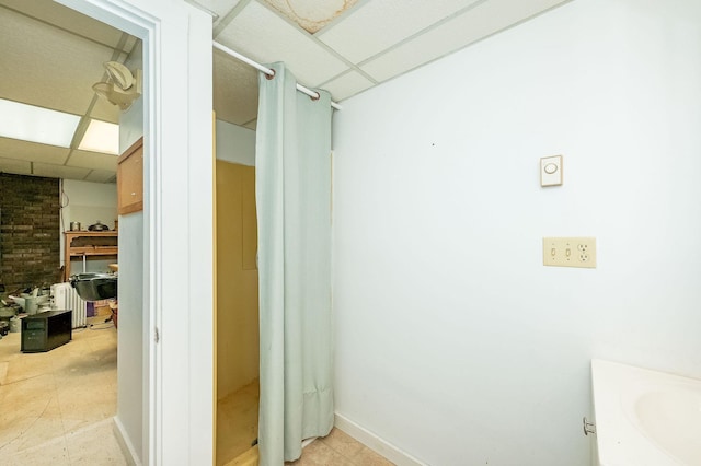 bathroom with vanity and a paneled ceiling