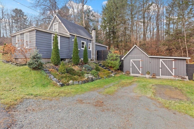 view of outbuilding featuring a yard