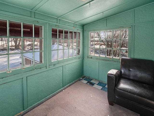 unfurnished sunroom featuring plenty of natural light and vaulted ceiling