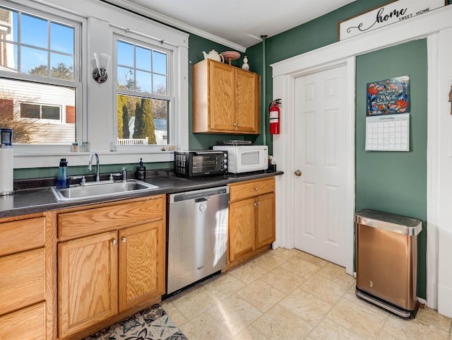 kitchen featuring ornamental molding, dishwasher, and sink