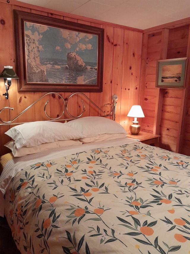 bedroom with wood walls