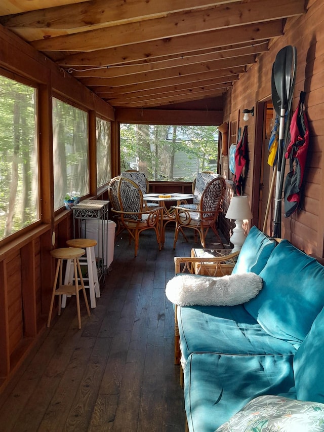 sunroom / solarium featuring lofted ceiling