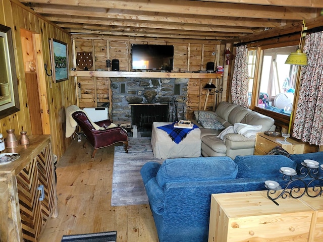 419 Belleau Blvd, Wakefield, NH 03830 - living area featuring wood-type flooring, wood walls, beamed ceiling, and a fireplace