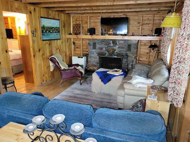 419 Belleau Blvd, Wakefield, NH 03830 - living area featuring wood finished floors, wooden walls, and a stone fireplace
