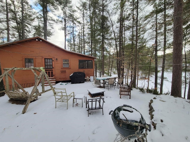 yard layered in snow featuring an outdoor fire pit