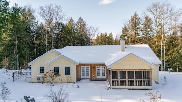 snow covered property featuring a sunroom