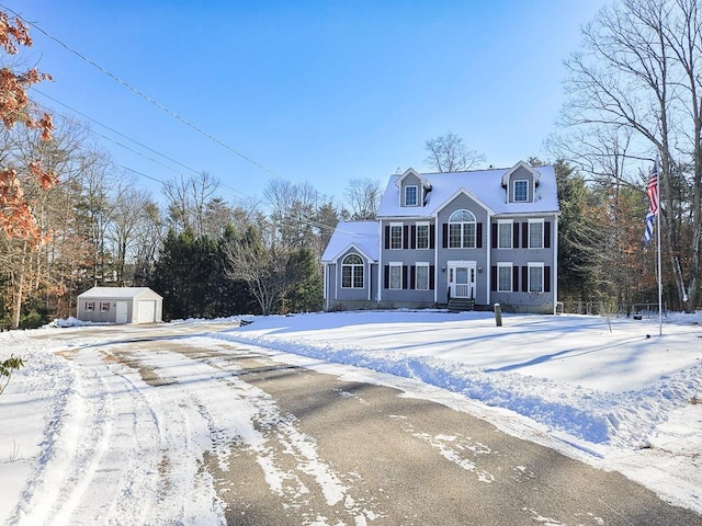 view of front of house with a garage and an outdoor structure