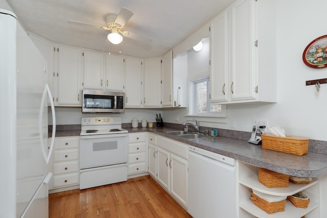 kitchen with white cabinetry, white appliances, sink, and light wood-type flooring