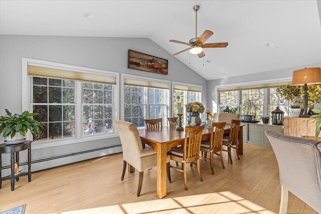 dining room featuring vaulted ceiling, a baseboard heating unit, ceiling fan, and light hardwood / wood-style floors