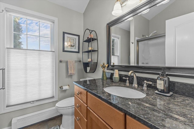 bathroom with baseboard heating, vanity, toilet, and walk in shower