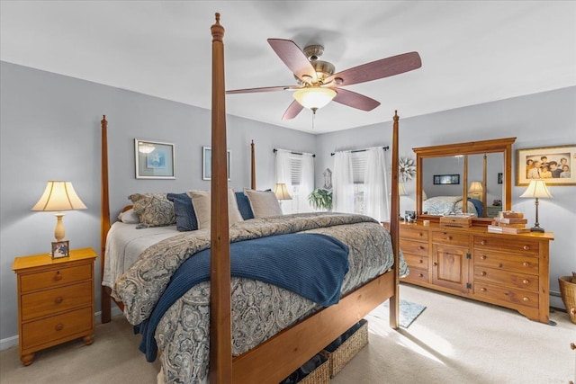 bedroom with light carpet and a baseboard heating unit