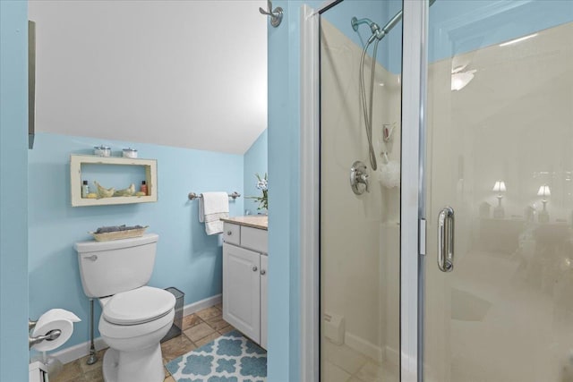 bathroom with vanity, vaulted ceiling, a shower with door, and toilet