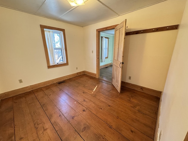 spare room featuring wood-type flooring