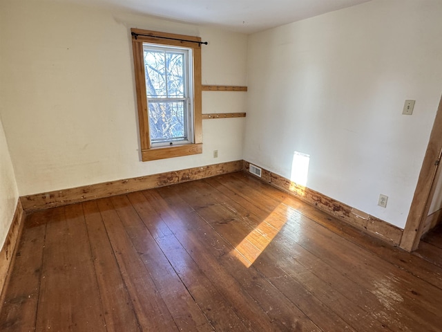 spare room with dark hardwood / wood-style floors