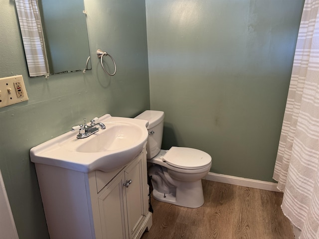 bathroom with vanity, hardwood / wood-style flooring, and toilet