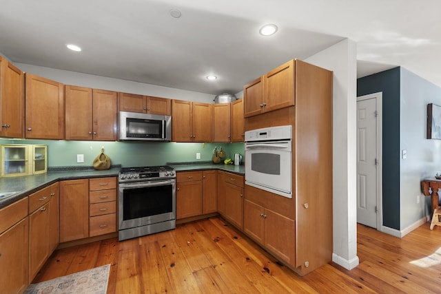 kitchen with stainless steel appliances and light wood-type flooring