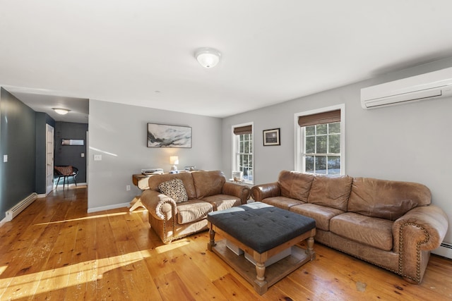 living room featuring a wall mounted air conditioner, light hardwood / wood-style flooring, and a baseboard heating unit