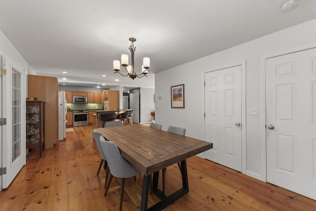 dining space featuring a chandelier and light hardwood / wood-style flooring