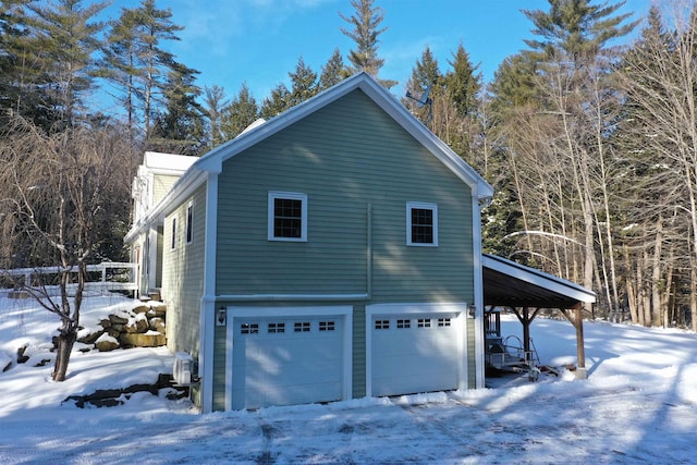 view of snow covered exterior featuring a garage