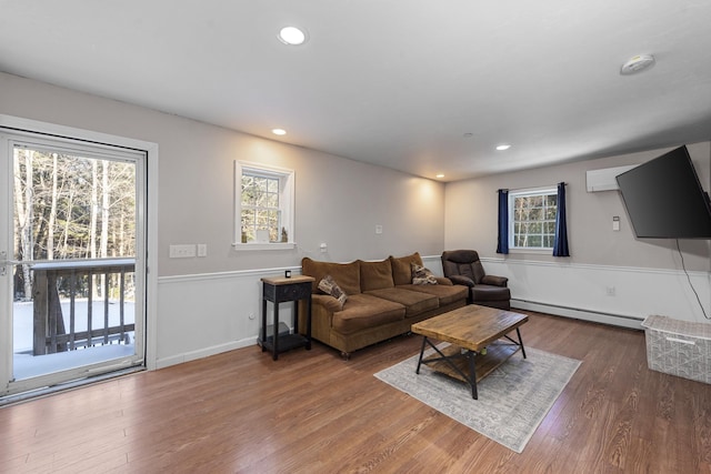 living room featuring dark hardwood / wood-style flooring and a baseboard radiator