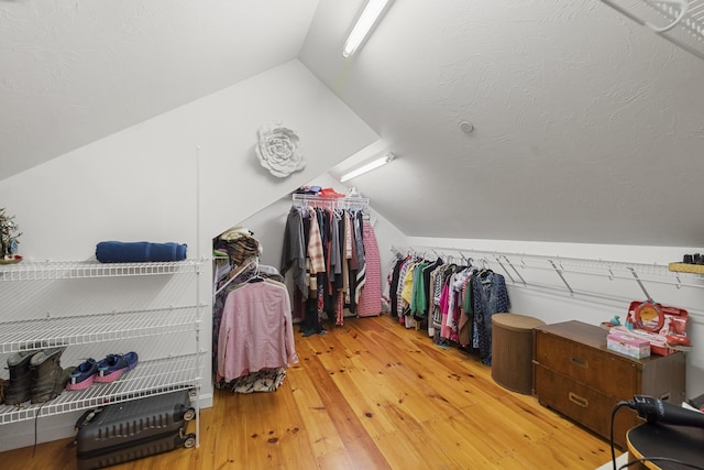 spacious closet with vaulted ceiling and wood-type flooring